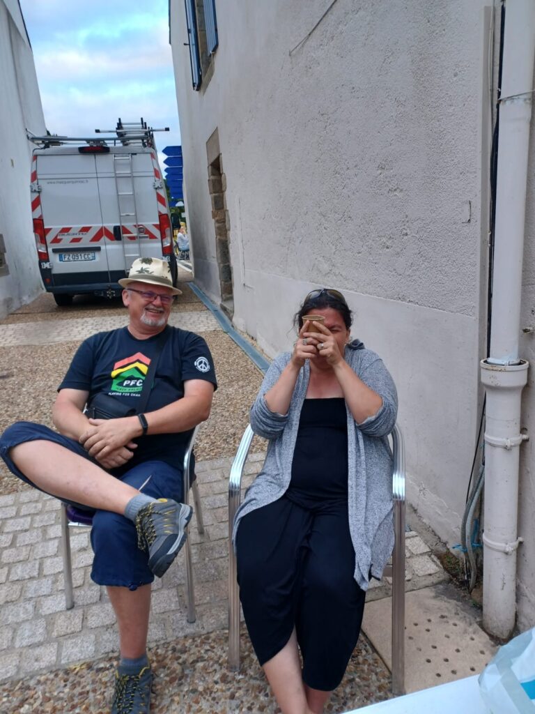 Homme souriant et femme riant assis dehors